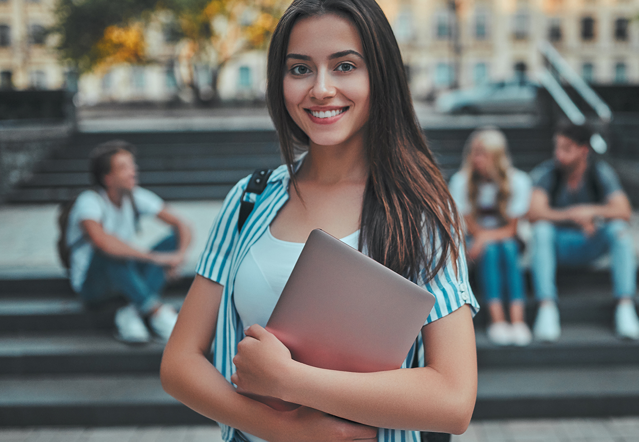 Young girl student holding books